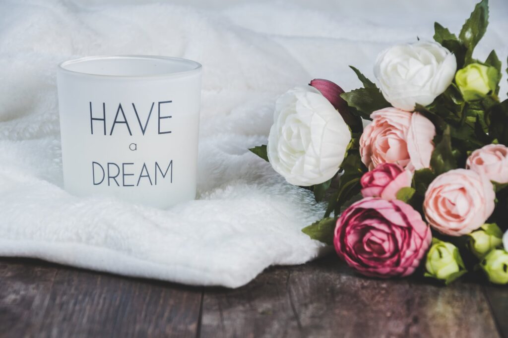 white and pink flowers beside a canister